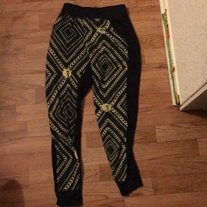 A gold chain sweat pants